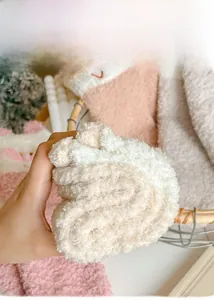 Close-up of thick coral fleece socks with cat ears embroidery and soft texture