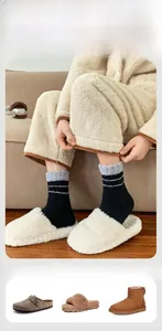 Detail of warm black and gray striped coral fleece socks paired with plush slippers