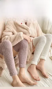Close-up of thick coral fleece knee-high leg warmers for winter comfort and warmth