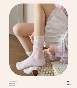 Detailed side view of pink mid-calf socks with white ribbon bows and bicolor cuffs