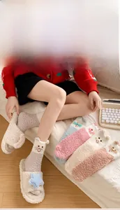 Close-up of cozy coral fleece cat socks and star plush slippers in a home setting