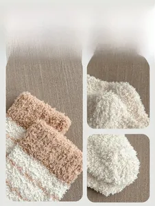 Close-up of thick coral fleece winter socks with striped pattern and soft plush texture