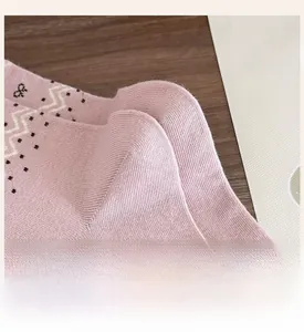 Macro shot of reinforced heel on pink heart bow sock with Nordic pattern details