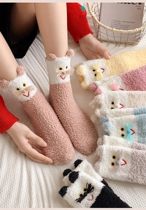 Close-up of thick coral fleece socks with 3D cartoon animal ears and soft winter texture