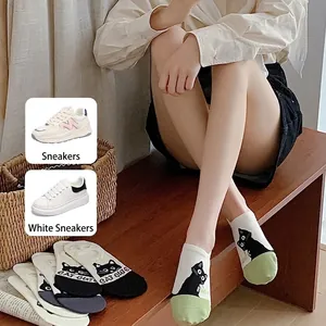 Women's low-cut no-show socks with cute black and white cat pattern and green toe detail