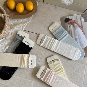 Japanese style hollow bow mid-calf socks in pastel cream colors with ruffled edges