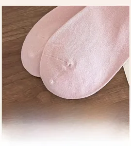 Macro detail of seamless toe design on light pink knit socks for ultimate comfort