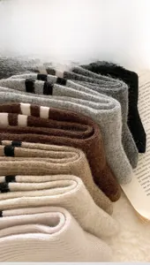 Close-up of thick winter wool socks in neutral colors with striped cuff details