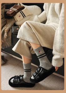 Close-up of cozy wool blend socks with stripe detail and cute puppy embroidery