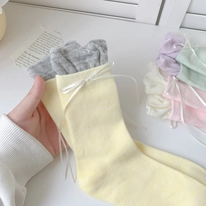 Sweet ballet style crew socks with ribbon bows and ruffled cuffs in pastel macaron colors