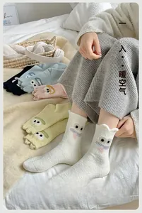 Close-up of thick winter socks with cute cartoon eyes and long tongue creative design