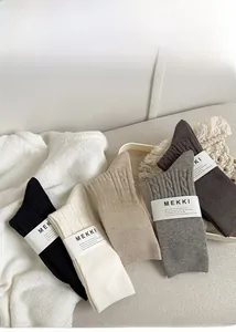 Detail of thick cable-knit texture and five neutral colors on warm winter socks