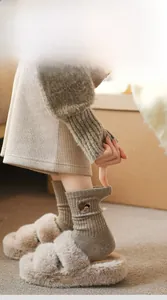 Close-up of khaki wool socks featuring cute bear embroidery and ribbed elastic cuffs
