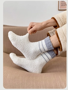 Detail of warm coral fleece socks with purple stripes showing elastic stretch fit