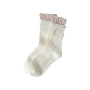 Sweet ballet style white crew socks with beige ruffled trim and delicate ribbon bow detail