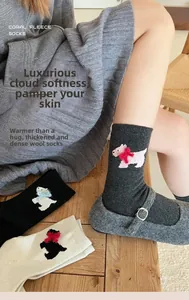 Close-up of thick wool coral fleece socks with cute puppy embroidery and bow ties