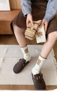 Thick coral fleece socks featuring cute bear patterns and warm striped texture detail