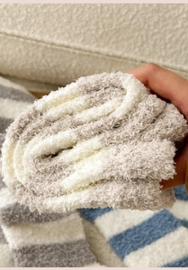 Close-up of thick coral fleece fabric showing the soft striped texture and thermal quality