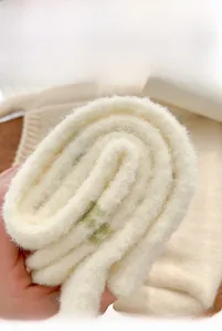 Detail of thick cream faux mink fleece socks showing soft plush texture and rolled cuff