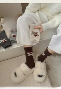 Gros plan de chaussettes en laine avec patchs d'ours en tons chauds d'automne