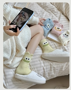 Cozy thick velvet socks and plush slippers with cute cartoon eyes in a home setting