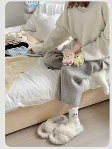 Detail of coral fleece winter socks with cute cartoon embroidery and fluffy texture