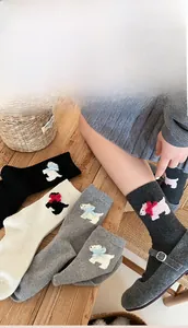 Detailed view of thick winter wool socks with cute 3D dog embroidery and colorful bows