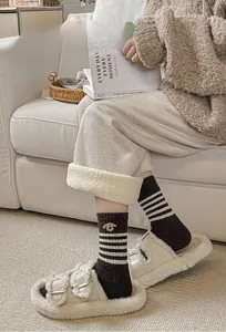 Detail of coffee brown striped wool socks with delicate animal embroidery on the side
