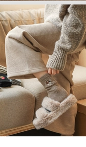 Close-up of brown wool socks with bear embroidery and textured knit ribbing details