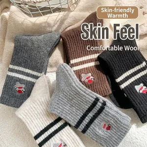 Cozy wool crew socks for women featuring cute animal embroidery and vintage stripes
