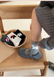 Close-up of winter wool crew socks with 3D Westie dog patches and cute bow details
