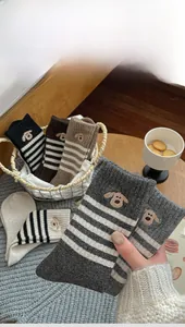 Detail of dog embroidery and striped knit pattern on wool blend crew socks