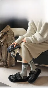 Detail of high-elasticity ribbed cuffs on grey knit crew socks with cartoon dog patterns