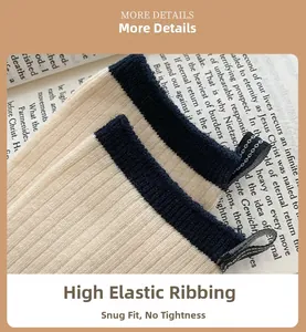 Close-up of cream ribbed cotton socks featuring navy blue stripes and elastic cuffs
