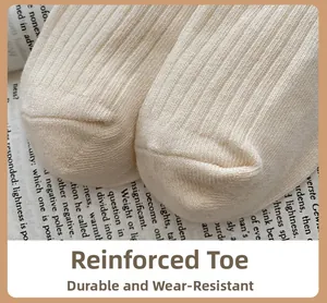 Close-up of ribbed knit cotton socks with reinforced toe design on newspaper background