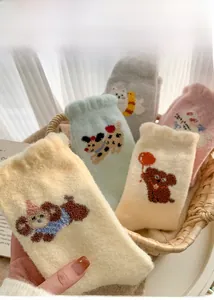 Detailed view of thick thermal plush socks with cute animal patterns and ruffled cuffs