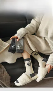 Detail of thickened knit socks with cartoon embroidery and reinforced heel design