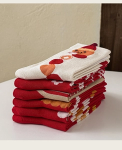 Dettaglio di calze festive in maglia rossa e crema con motivi a cartoni animati