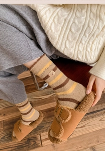 Detailed view of warm winter striped crew socks with a cute small bear embroidery patch