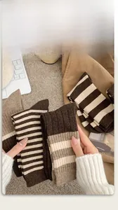 Close-up of striped wool socks with ribbed cuffs in brown and beige earth tones