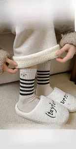 Detailed texture of thick wool socks with dog embroidery and striped knit pattern