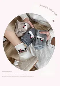 Detail of wool blend socks with cute dog embroidery and stylish rolled cuffs