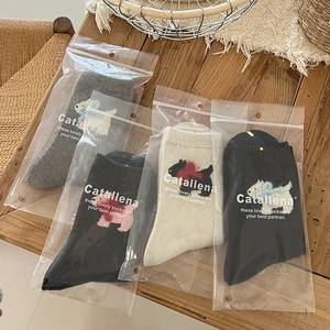Four pairs of thick wool socks with 3D flocking puppy and bow details in gift bags