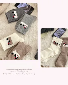 Close-up of knitted mid-calf socks with cute 3D embroidered puppies in multiple colors