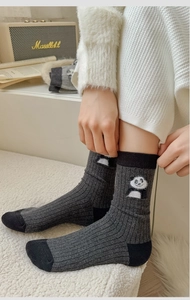 Detail of dark grey crew socks with cute panda embroidery and ribbed knit texture