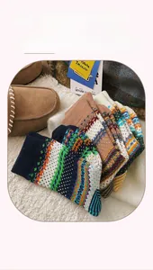 Close-up of Fair Isle knit socks in vintage ethnic patterns with brown suede loafers