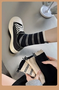 Close-up of cotton knit crew socks with stripe patterns and elastic ribbed texture