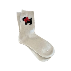 Cozy cream wool mid-calf socks with black terrier dog pattern and red bow details