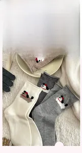 Detailed close-up of wool-blend mid-calf socks with cute cartoon puppy embroidery details