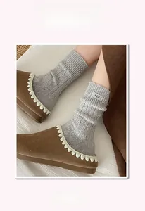 Detail of light gray wool socks with egg label and elastic ribbed cuffs for women